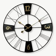 Large 60 cm factory-style metal wall clock in black with gold numerals on a living room wall