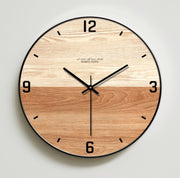 Double-shade round wooden wall clock with natural wood grain on a white wall