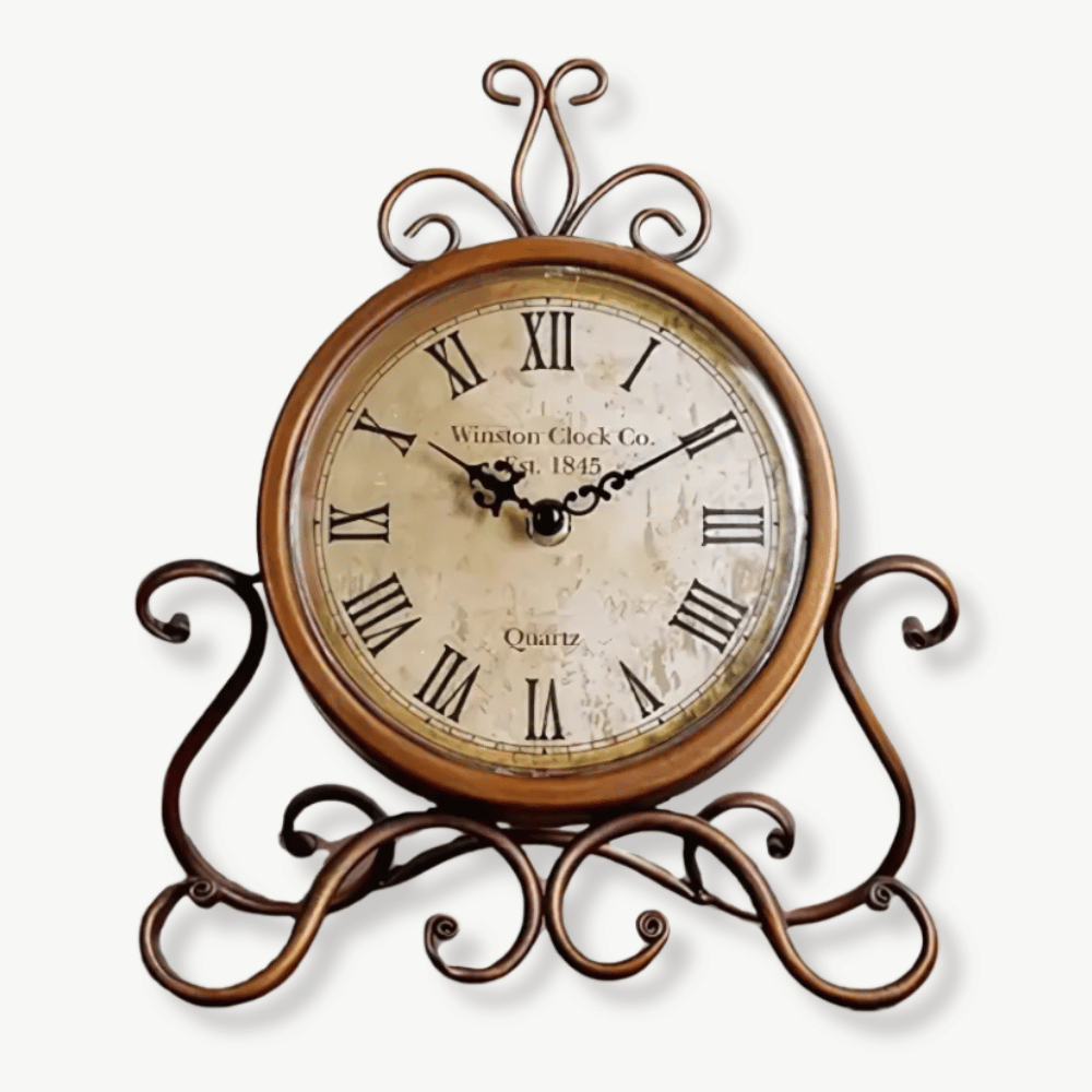 Antique-style bronze iron tabletop clock on a wooden desk