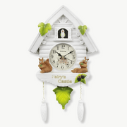 White cuckoo wall clock with 3D flowers and treehouse design on white background
