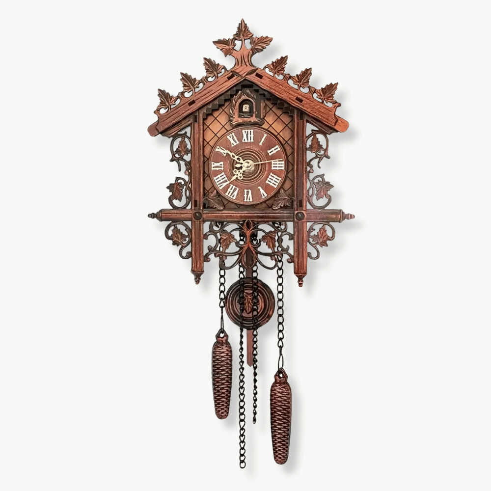 Vintage wooden cuckoo wall clock in black on a white wall