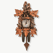 Vintage owl cuckoo wall clock with retro design on white wall