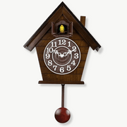 Mechanical cuckoo wall clock with swinging pendulum and Roman numeral dial