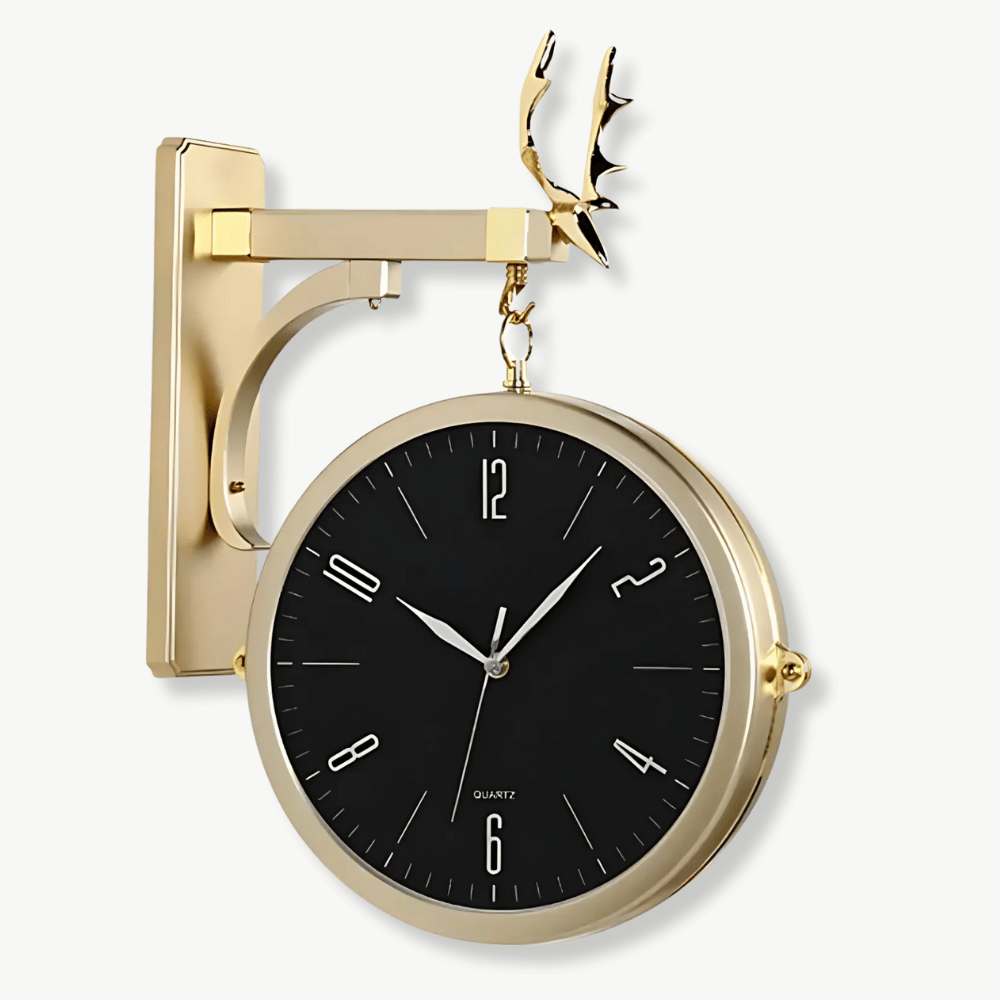 Modern double-sided wall clock in gold and black finish mounted on a white wall