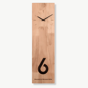 Natural bamboo wall clock with Japanese zen design on a white wall