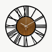 Scandinavian bamboo wood wall clock with metal Roman numerals on a white wall