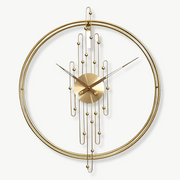 Art Deco round metal wall clock with no-number dial on a light living room wall