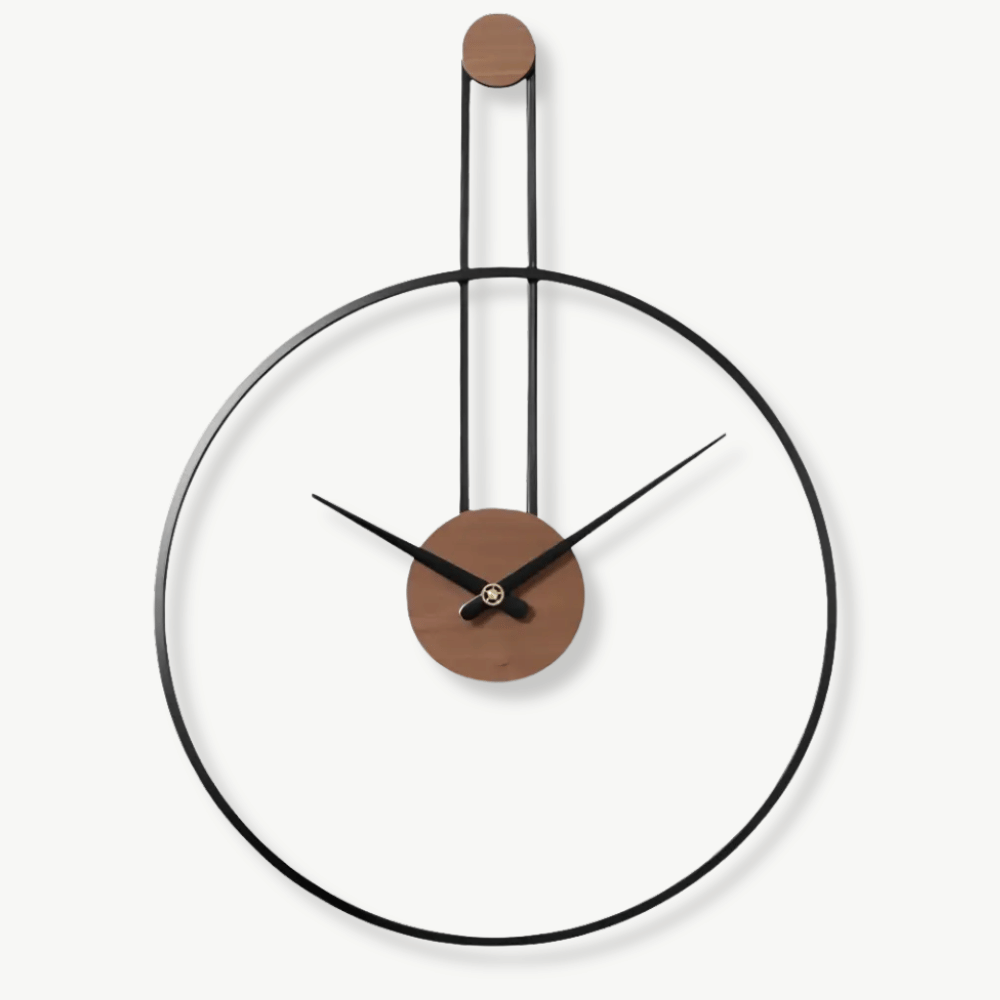 Suspended circle metal wall clock in black finish on a white living room wall