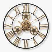 Golden gear wall clock with 3D metal design on a white wall