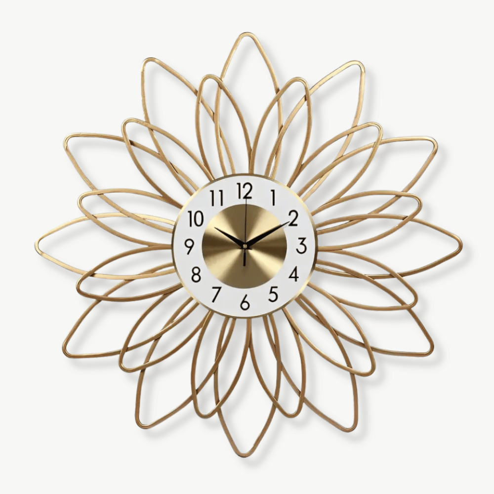 Golden flower metal wall clock with analog hands on a white wall