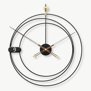 Modern geometric metal wall clock with unique dial pattern on a white wall