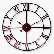 Industrial copper red metal wall clock with analog hands on a white wall