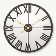 Black and gold circular mirror wall clock 58 cm on a light wall