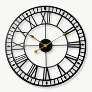 Retro industrial metal wall clock 40 cm with gold hands on a white wall