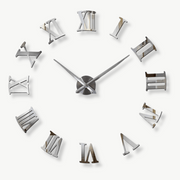 Roman numeral sticker wall clock in black on a white living room wall