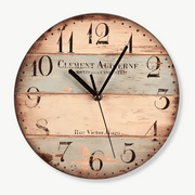 Vintage wooden wall clock with distressed black numerals on white wall