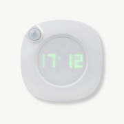 Motion-activated digital wall clock with LUMINOVA display on white wall