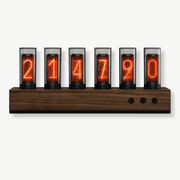 Vintage Nixie tube wood clock with glowing glass tubes on a desk