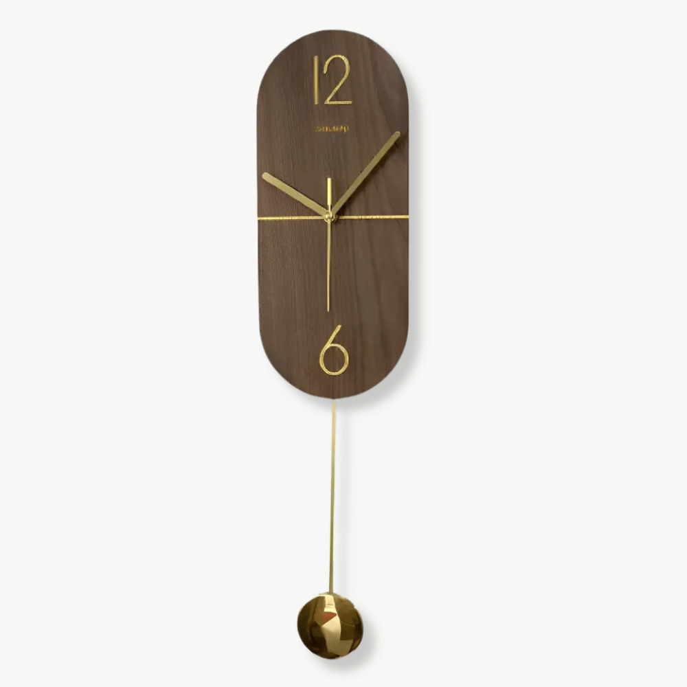Linea walnut and gold pendulum wall clock hanging on a white wall