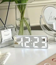 LED mirror digital clock showing time and temperature on a desk