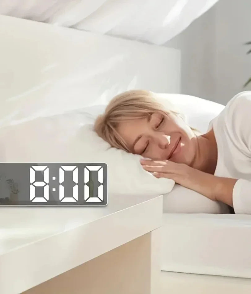 White LED mirror clock on a dorm room nightstand