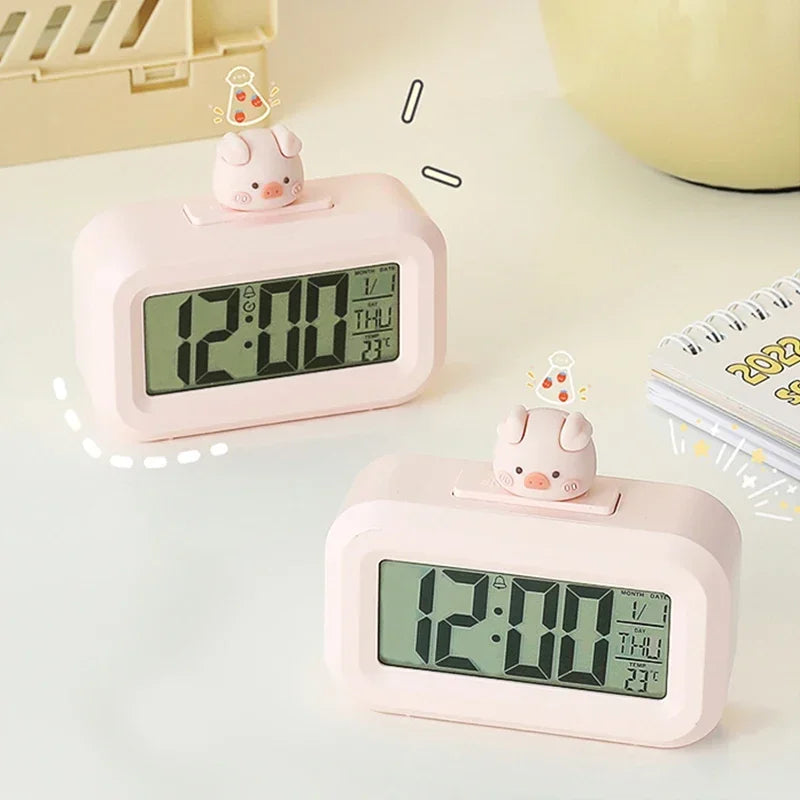 Bedside LED alarm clock in pig design showing time display in the dark