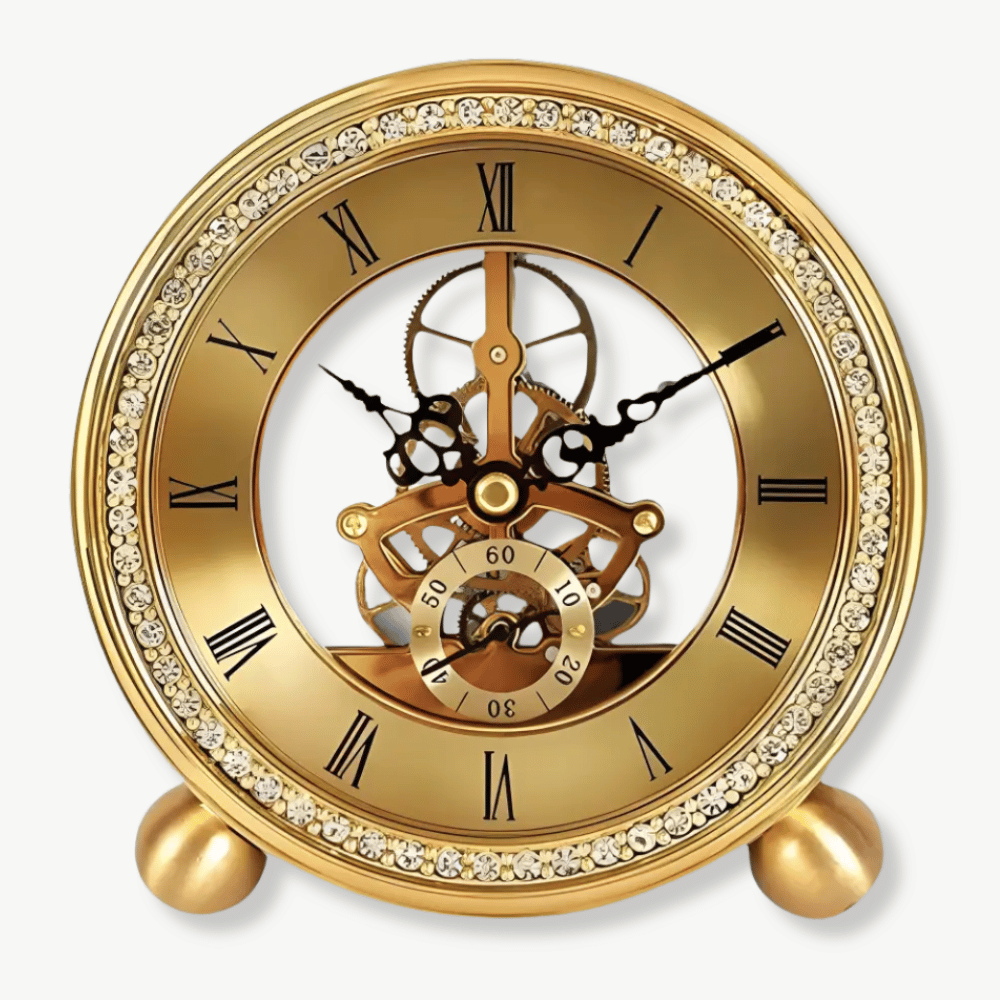 Golden brass tabletop clock with exposed mechanism on a wooden desk