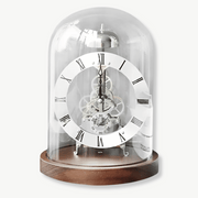 Tempus Machina mechanical tabletop clock with glass dome and black walnut base in gold finish