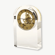 Transparent glass and crystal desk clock with antique design on a wooden desk
