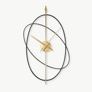 Luxury rings silent wall clock with oval metal frame on a living room wall