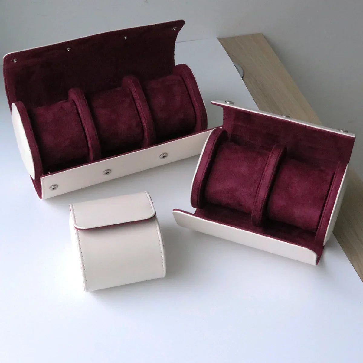 Black leather watch case with 2 slots on a wooden surface