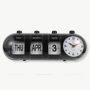 Vintage calendar alarm clock with flip display in black on a nightstand