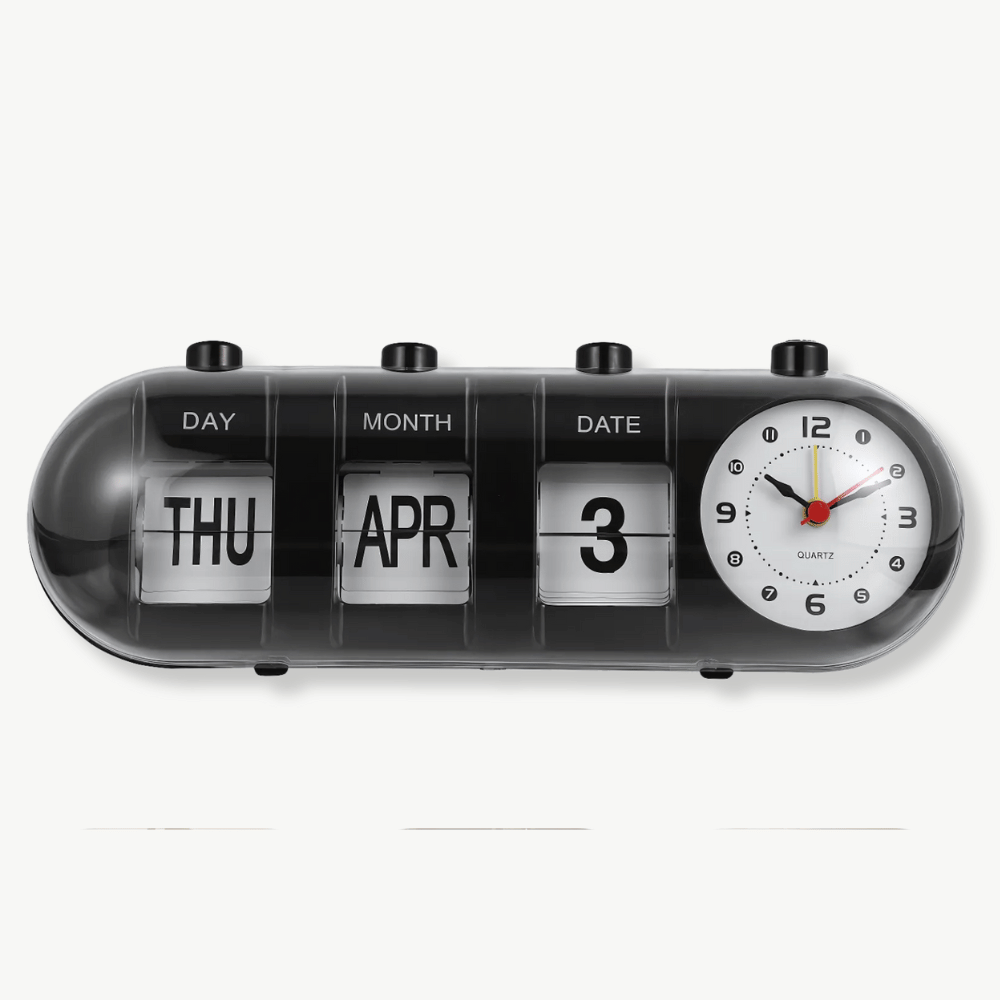 Vintage calendar alarm clock with flip display in black on a nightstand
