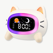 Cute cat-shaped LED alarm clock on a bedside table