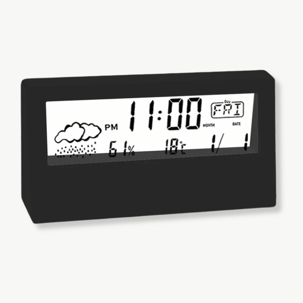 Black LCD weather alarm clock showing time temperature and humidity on nightstand