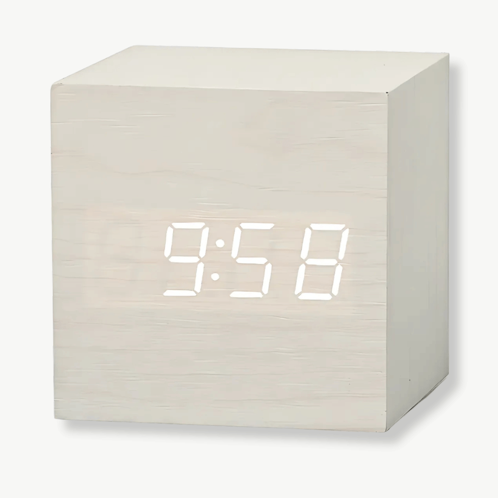 Square LED alarm clock with dark wood frame on a bedside table