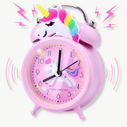 Pink unicorn alarm clock with dual bell on a kids bedroom nightstand