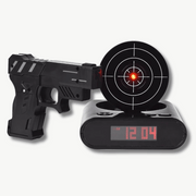 Target shooting alarm clock with laser gun on white background