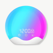Sunrise alarm clock with warm multicolor glow on a bedside table