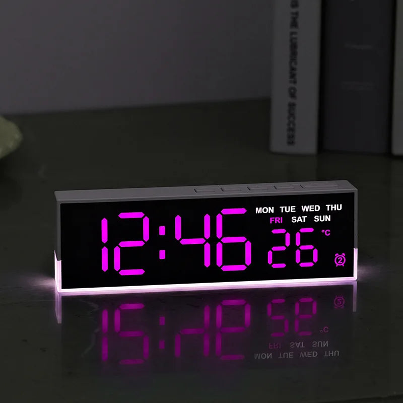 LED digital alarm clock with ambient light glowing on a bedside table