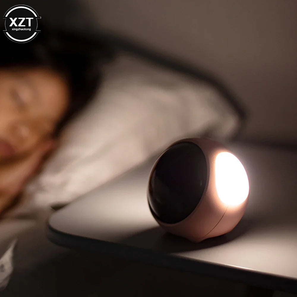 Close-up of emoji face display on compact digital alarm clock