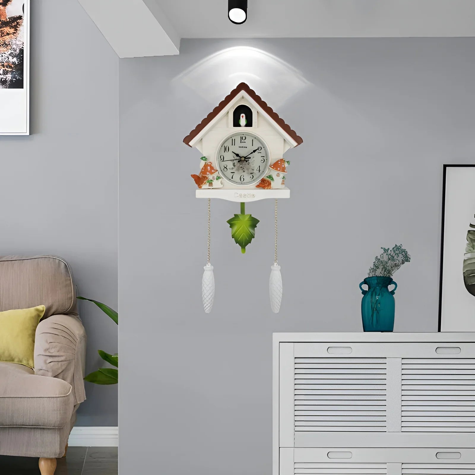 Leaf-shaped pendulum swinging on decorative cuckoo wall clock