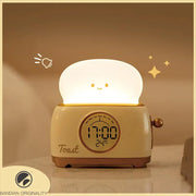 Green toaster-shaped LED kids alarm clock with night light on nightstand