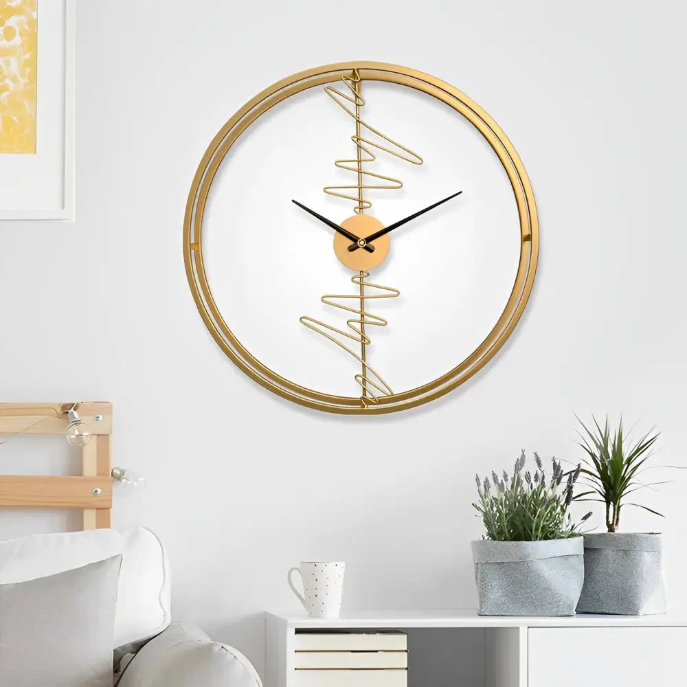 Gold finish large round wall clock with abstract detail on white wall
