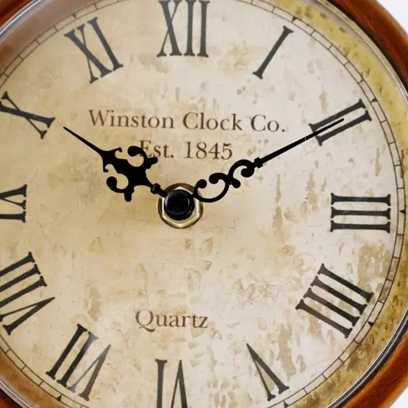 Bronze finish metal shelf clock in a home office setting