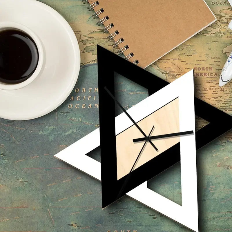 Black and white triangle clock mounted in a contemporary kitchen setting