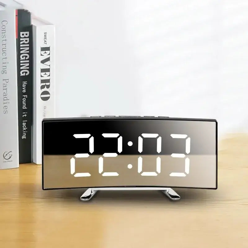 Curved LED alarm clock showing alarm and weekly day display