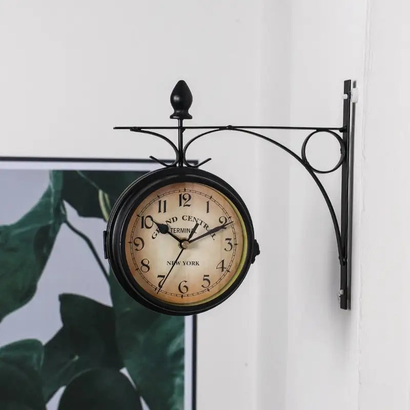 Close-up of hand-painted antique finish iron frame on station wall clock