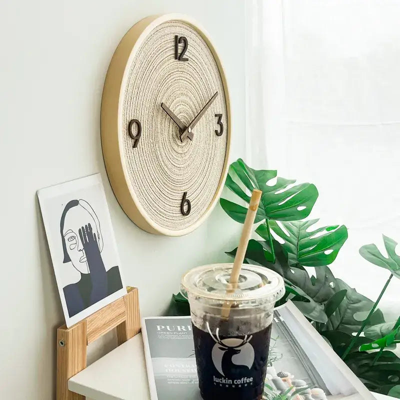Detail of analog hands on fabric dial bamboo wall clock
