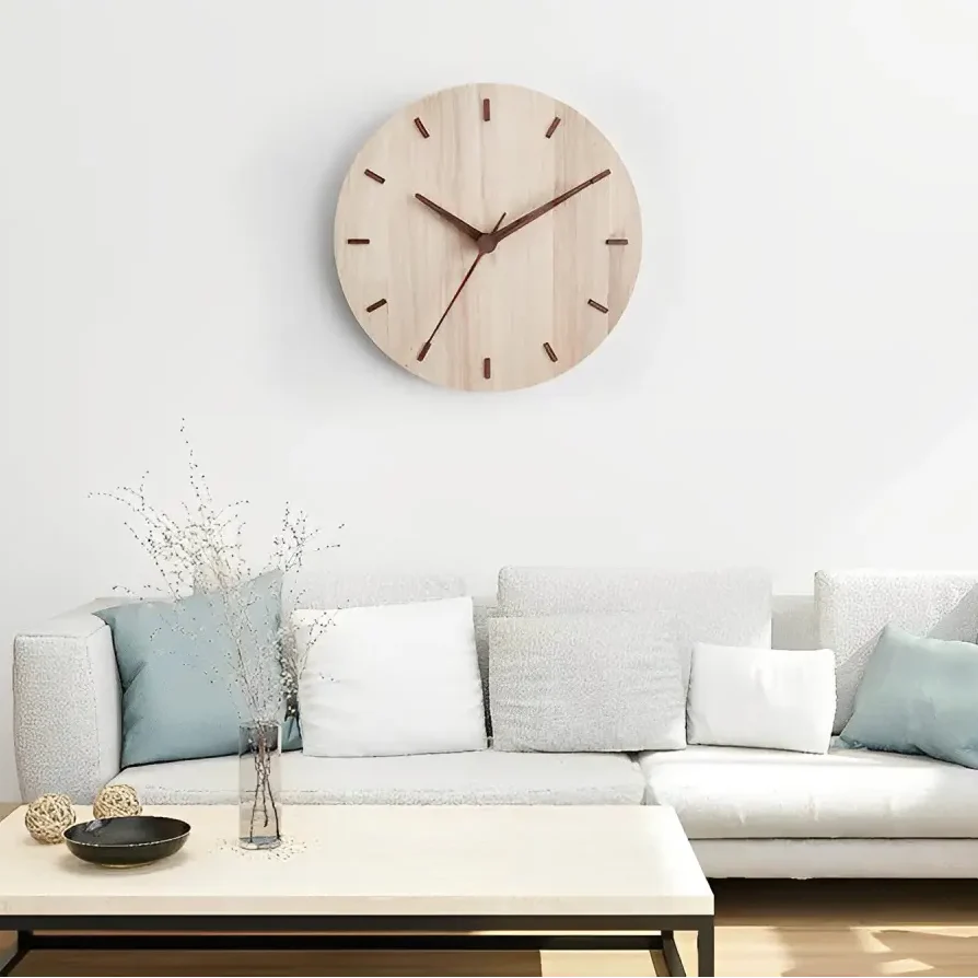 Close-up of analog hands on natural wood wall clock